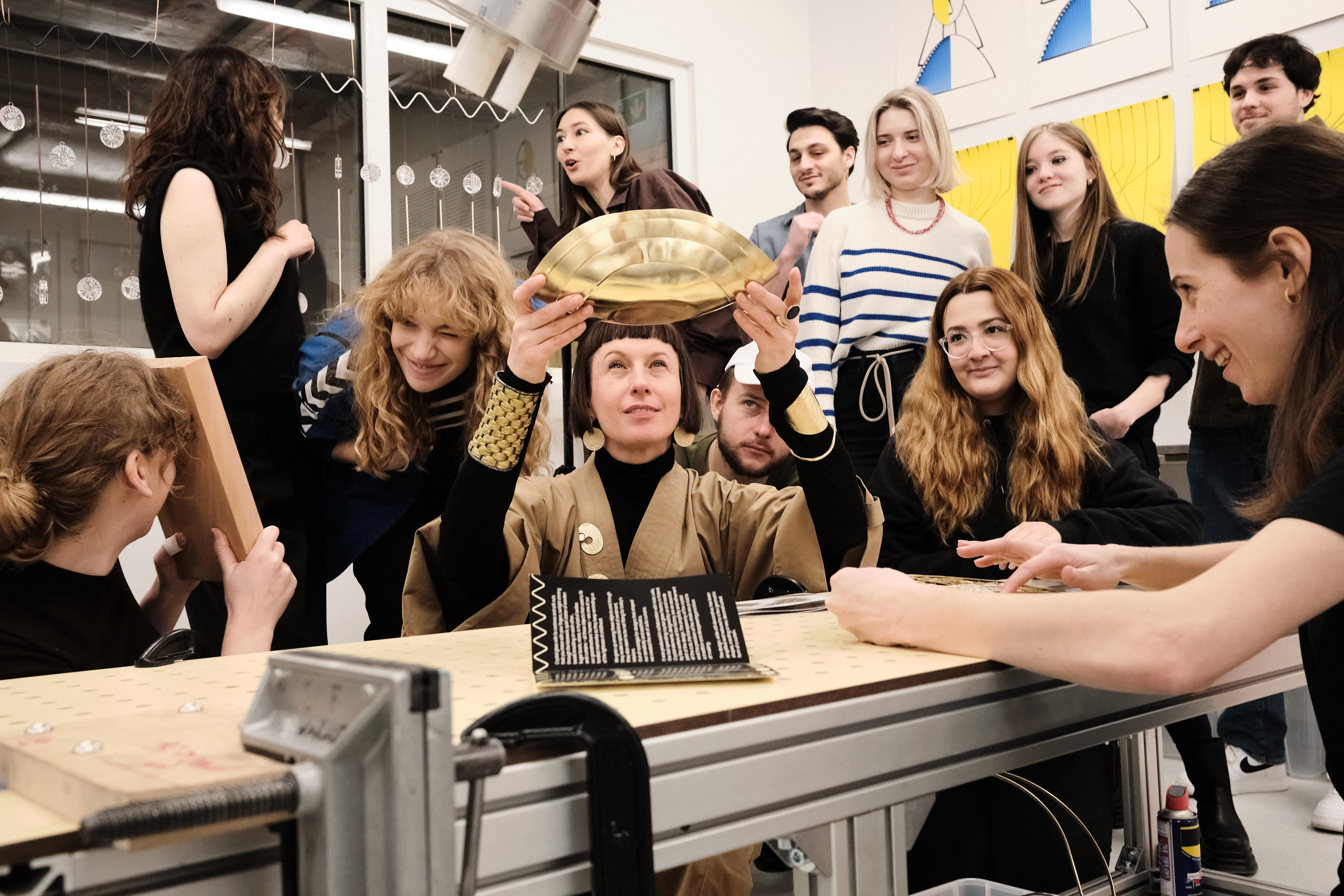 A group of students at a workshop with jewelry designer Anna Orska